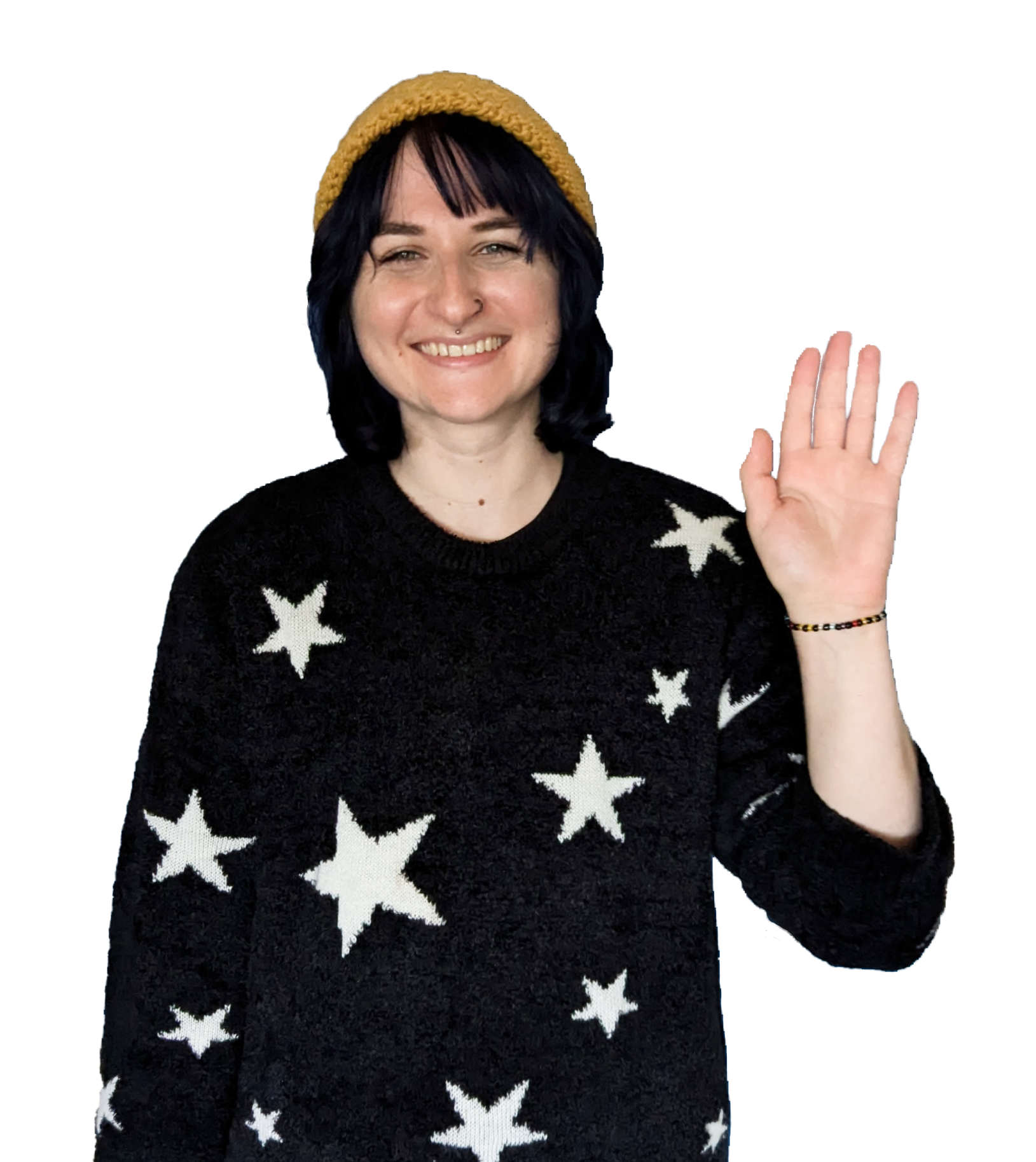 Erin smiles and waves while wearing a yellow beanie and black and white sweater